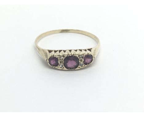 A 9carat gold ring set with three ruby. ring size T.