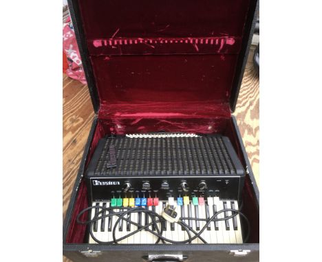 A cased Chestron accordion.