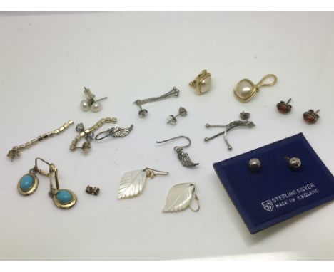 Ten pairs of earrings including silver and mother of pearl examples.