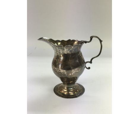 A silver cream jug, London 1773.