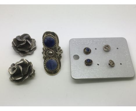 Three pairs of silver earrings and a silver ring set with Lapis Lazuli.