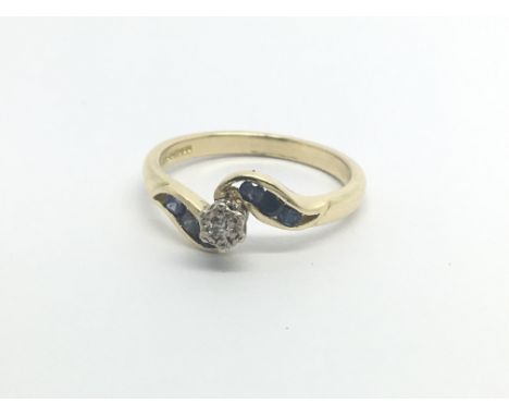 An 18carat gold ring set with a diamond flanked by sapphire ring size N-O