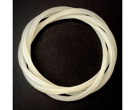A rare Chinese milk glass four piece bangle imitating white jade. Each bangle 4mm, internal dia. 6cm.