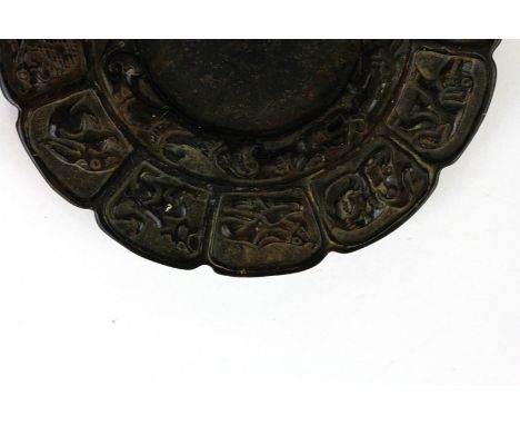 A Chinese carved brown jade/ hardstone ink grinding stone decorated with the twelve-year signs, Dia. 8cm.