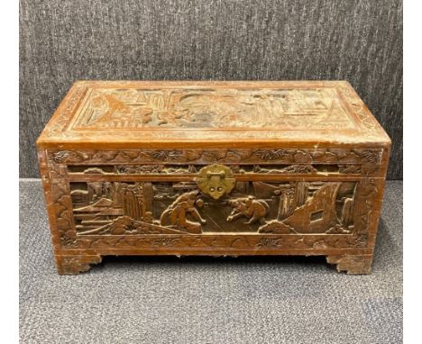 A Chinese carved camphor lined trunk, 79 x 38 x 38cm.