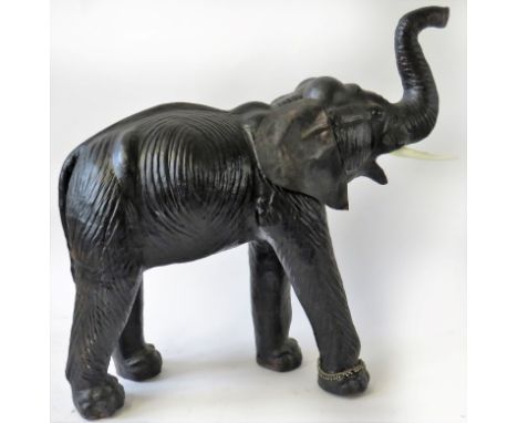 A contemporary leather model of an elephant With raised trunk, height 93cm, length 95cmADDITIONAL INFO/CONDITION REPORT Age m