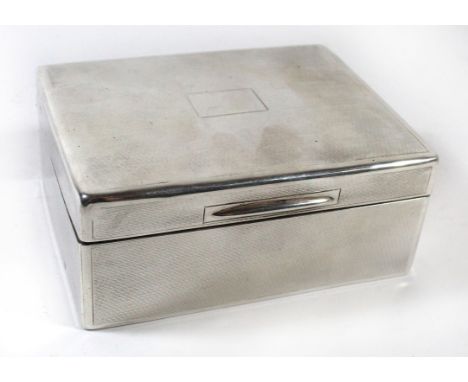 A George V silver cigarette box Of hinged rectangular form, the body decorated with engine turned detail, the interior with w