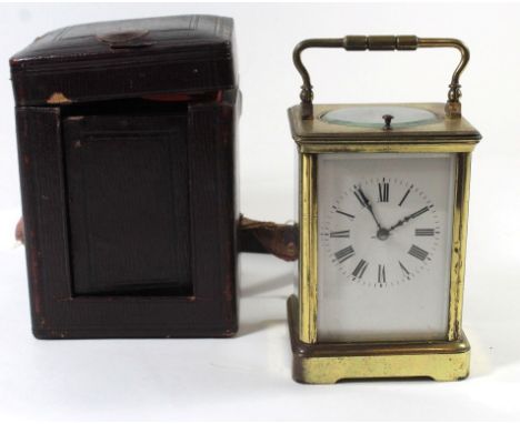 A late 19th/early 20th Century brass framed carriage clockWith white enamel dial with Roman numerals, brass twin train moveme