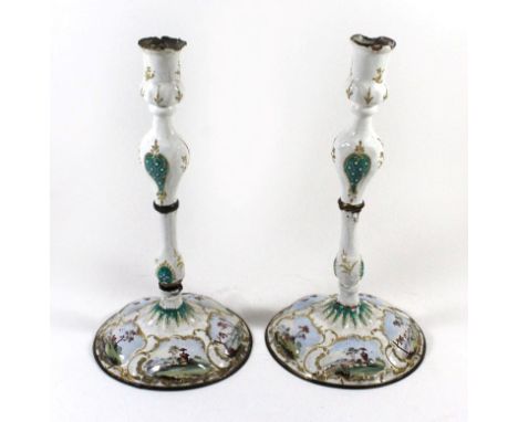 A pair of antique Bilston style enamel on copper candlesticksOf baluster form, raised on spreading circular bases, decorated 