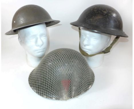 A green painted British Army helmet, late 20th CenturyWith net cover and red painted triangular decal, further green painted 