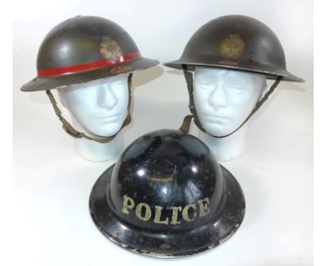 Three WWII period painted metal helmetsTo include two fire service helmets no. 26 and 40, black painted police helmet (3) 
