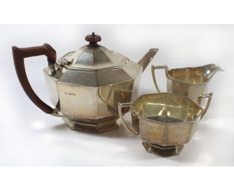 A George III three piece silver tea setOf octagonal form, comprising teapot with composition handle and lid finial, together 