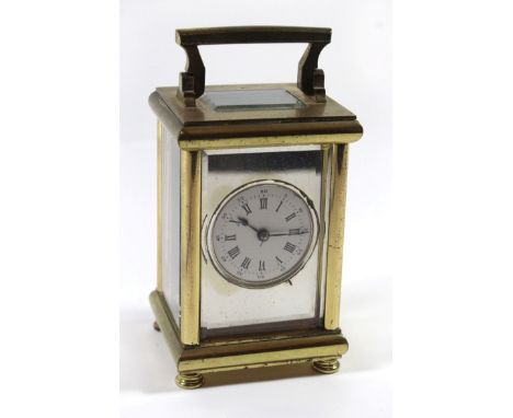 A 20th Century brass framed French carriage clockThe silvered face with central white enamel dial with Roman and Arabic numer