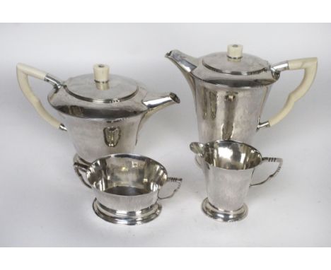 An Art Deco hallmarked silver four piece tea serviceEach having planished decoration to body, the teapot and water pot with i