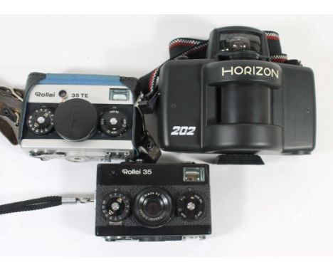Vintage Cameras - A  Russian Krasnogorsk Horizon 202 Panoramic CameraTogether with a Rollei Singapore 35 TE and Rollei 35 cam