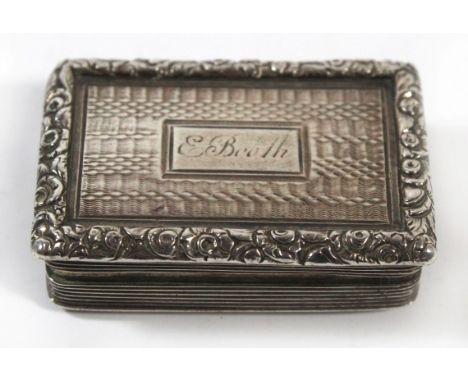 A George IV silver vinaigretteOf hinged rectangular form, the body with floral moulded border engine turned decoration and en