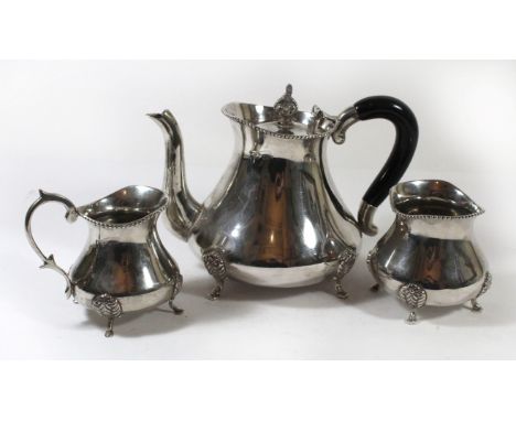 An Indian white metal three piece tea serviceComprising teapot, sugar basin and milk jug, all raised on four swept feet, two 