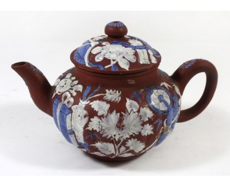 A Chinese Yixing teapotPainted in enamel with objects and flowers, impressed mark to base, height 11cm.ADDITIONAL INFO/CONDIT