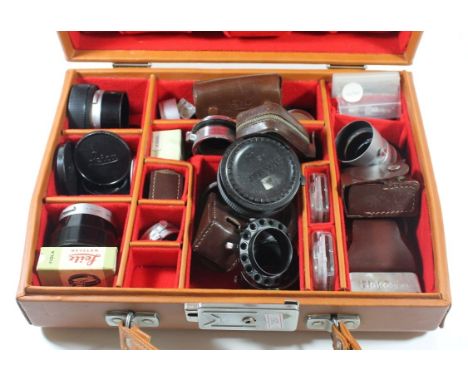 Camera Accessories - A brown leather case containing a range of Lietz and other lensesTubes, Lens caps, light meters and othe