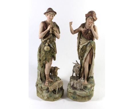 A pair of Royal Dux models Shepherd and Shepherdesswith attendant goats and sheepRaised on rocky plinths, pink lozenge marks 