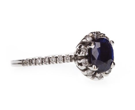 A BLUE GEM AND DIAMOND RING, set with a central oval faceted blue gem 7mm long within a diamond halo, on diamond shoulders, m