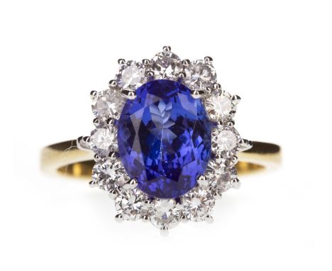 TANZANITE AND DIAMOND RING, set with a central oval faceted tanzanite of approximately 2.00 carats within a diamond halo, in 