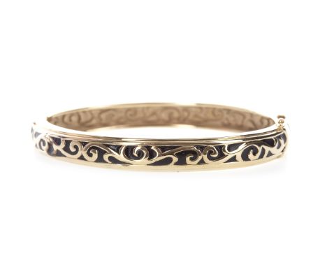 GOLD BANGLE, of oval form, with black painted decoration, in fourteen carat gold, 67mm inner diameter, 8.9gPlease see ‘Import