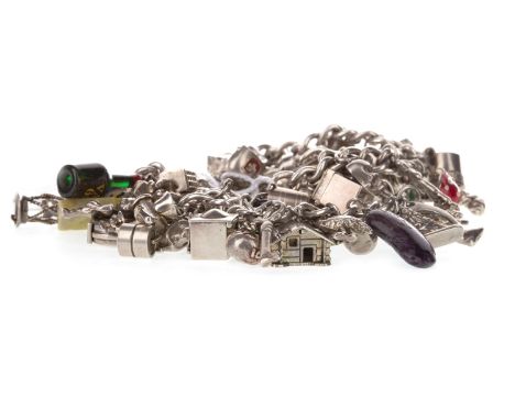 SILVER CHARM BRACELET, formed by two curb link sections, heavily populated with charms including a whale and a miniature deck
