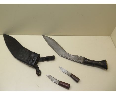 A horn handle Kukri with 31cm blade in leather covered wood scabbard together with its accompanying Karda and Chakmak with bu