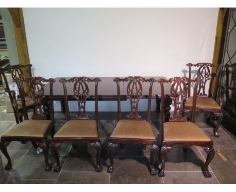 A 19th century style pull out mahogany dining table with one leaf on turned reeded legs with six Chippendale style chairs inc