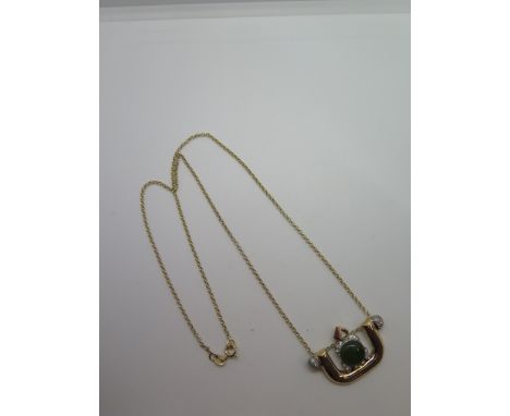 A yellow gold diamond and jade pendant 33mm x 20mm on a 9ct yellow gold chain 46cm long, pendant tests to approx 15ct, total 