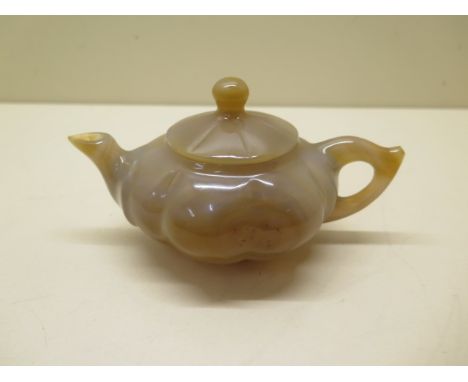 A Chinese 20th century carved agate gould shape teapot and cover - 15cm x 7.5cm - good condition 