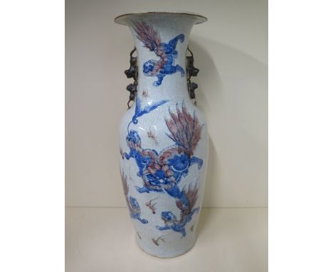 A large Chinese 19th/early 20th century vase decorated with Fu-Lion dogs in an iron red and blue on crackle glaze ground - se