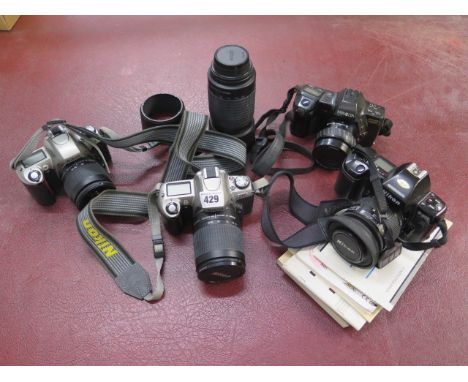 A collection of 4 x 35mm cameras to include two Nikon F65 cameras serial no 3087036 and 2358602 both with Nikon AF Nikkor 28-