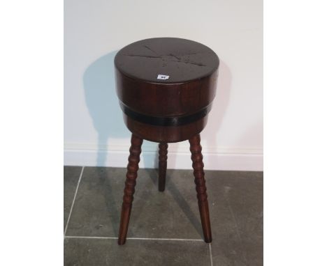 A French circular Butchers block with metal band standing on three bobbin turned splay legs - height 80cm x diameter of top 3