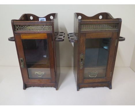 Two very similar Victorian oak glazed cabinets with single drawer and folding pipe racks each side - height 32.5cm 