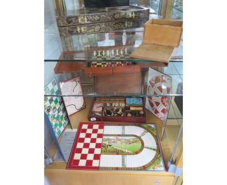 A mahogany games compendium, an Oriental chess/backgammon board, a part travelling chess set and draughts 