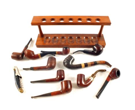 A Briar and other wood pipe collection, two with Gold bands, one Silver and rack and knife