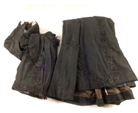 A vintage black beaded top and gown with white lace cuffs