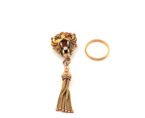 A Gold Lions head pendant set with a Diamond in its mouth with tassel plus a 9ct Gold band