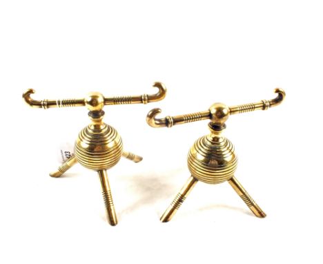 A pair of Christopher Dresser design globular Brass fire dogs on tripod feet