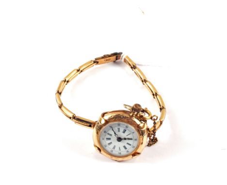 A 14ct lady's fob watch upon a Gold plated strap