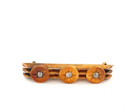 A Gold (tested) three Diamond set bar brooch