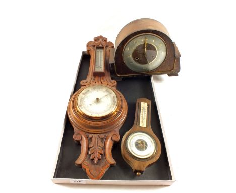 An Oak aneroid barometer, a small one and an Oak cased mantel clock