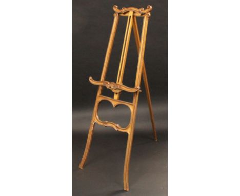 A Louis XV Revival giltwood gallery easel, carved throughout with scrolls and acanthus, outswept legs, 151.5cm high, the adju