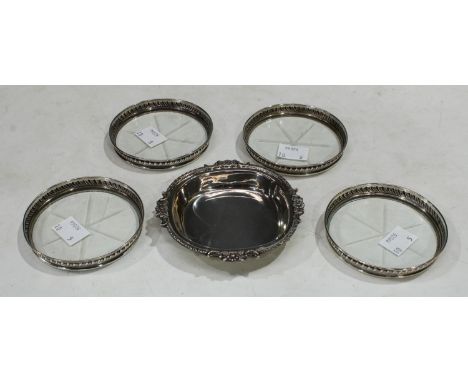 A set of four sterling silver and clear glass coaster; a small tray, marked silver (5) 