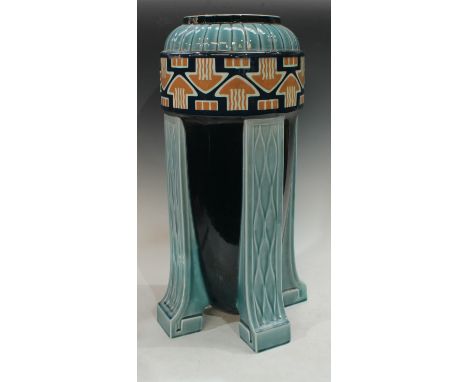 A continental Art Deco bullet shaped umbrella/stick stand, applied with a band of arrow motifs, glazed in shades of blue and 