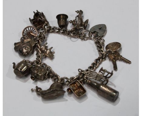 A silver curb link charm bracelet, assorted charms, pianist, cine camera, magic lantern, rocking chair, etc, 47.4g 