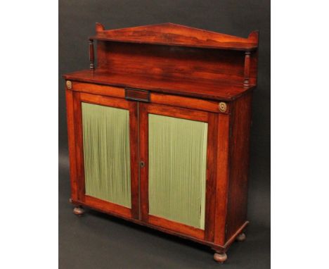 A George IV gilt metal mounted rosewood library pier cabinet, pointed arched superstructure, with rounded rectangular shelf, 