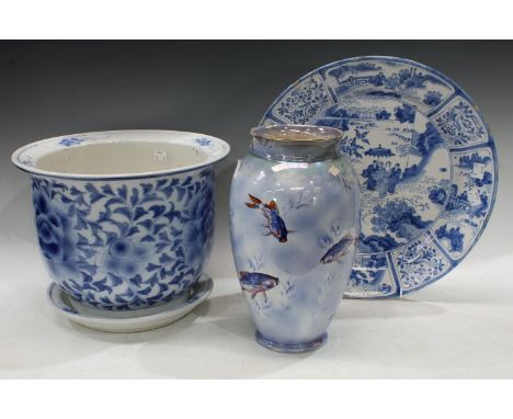 A tin glazed charger, rivets to verso, painted in blue on a white ground, figures in landscaped gardens; a Burleigh Ware vase